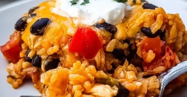 Cheesy Chicken Taco Casserole topped with melted cheese and fresh toppings.