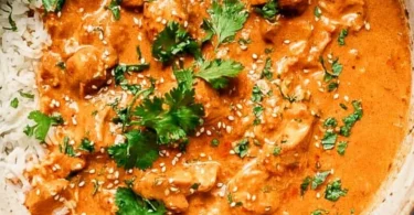 Delicious Crockpot Butter Chicken served with rice and naan bread