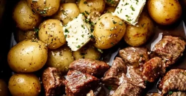Crockpot Garlic Butter Beef Bites served with potatoes in a bowl