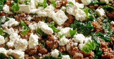 Ground beef and spinach skillet dish topped with feta cheese