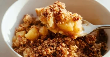 Healthy breakfast apple crumble topped with oats and fresh apple slices