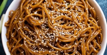 Delicious homemade Hibachi Noodles garnished with vegetables and sauces