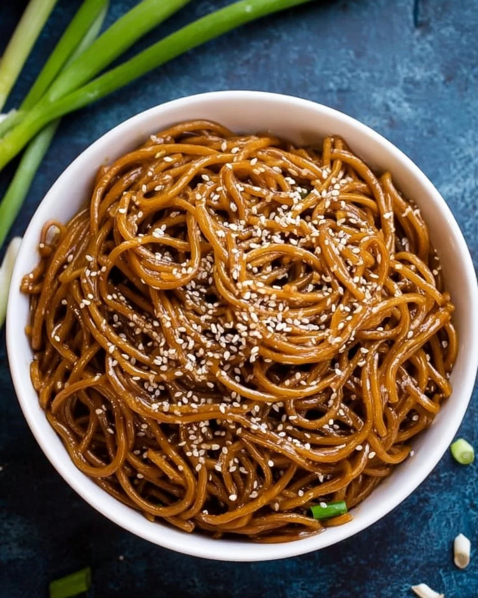 Delicious homemade Hibachi Noodles garnished with vegetables and sauces