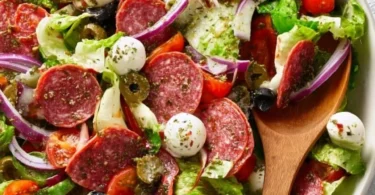 Colorful Italian salad with fresh vegetables and herbs in a bowl.