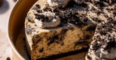 Delicious Oreo Cookie Cake topped with crushed Oreos and creamy frosting