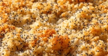 Delicious Pioneer Woman Poppy Seed Chicken Casserole topped with poppy seeds.